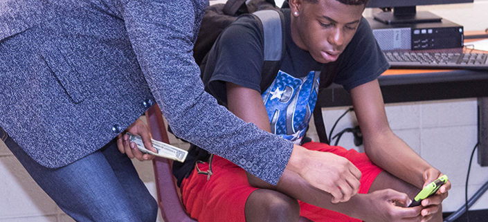 Eric Sloan, Jr. assisting students